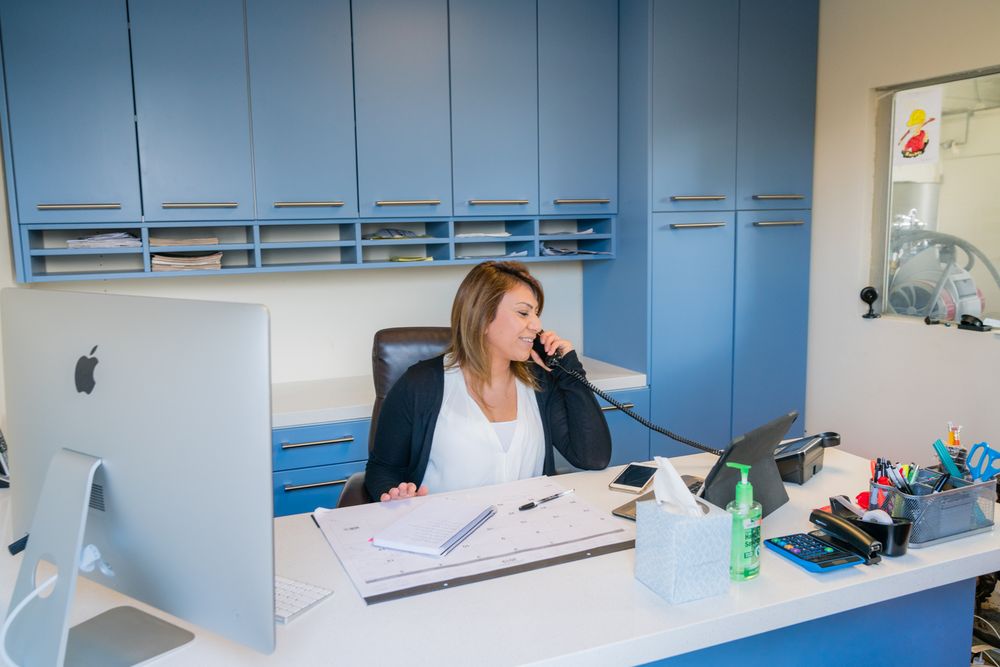 Hard Hat Rooter office staff taking a customer call