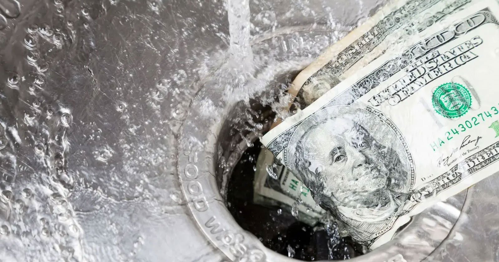 Hundred dollar bills washing down a running sink drain