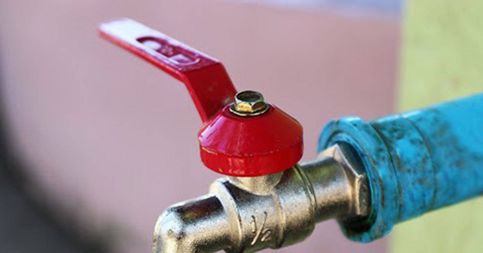 Red lever handle on a brass water shutoff valve